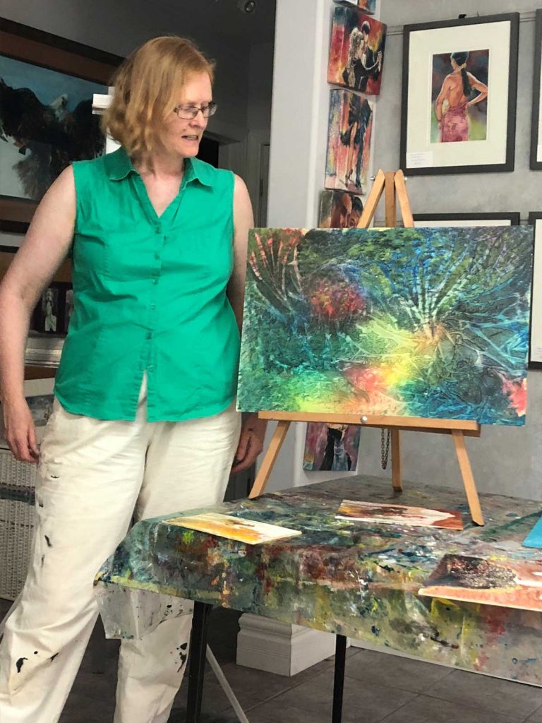 Pam showing a painting at a workshop.